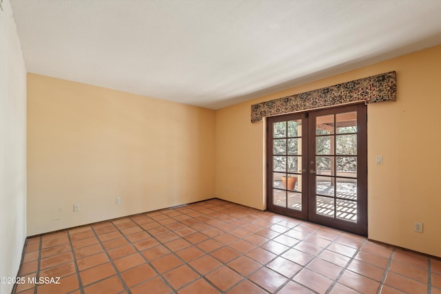 tiled spare room with french doors