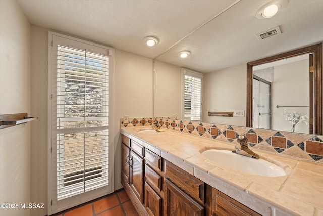 full bathroom featuring double vanity, tile patterned flooring, a sink, and visible vents