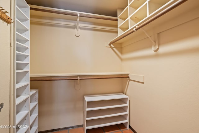 walk in closet with tile patterned flooring