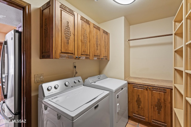 clothes washing area with cabinet space and washing machine and dryer