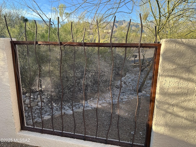 view of gate featuring fence and a mountain view