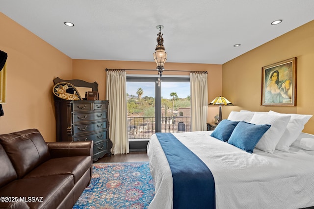 bedroom with access to outside, dark wood finished floors, and recessed lighting