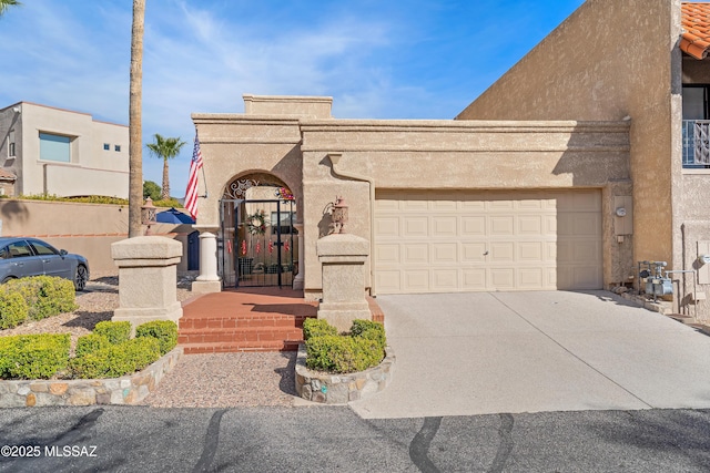 view of front of house featuring driveway, an attached garage, and stucco siding