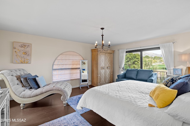 bedroom featuring dark wood-style floors and an inviting chandelier