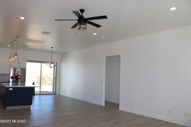 unfurnished living room with dark wood-style floors, visible vents, and recessed lighting