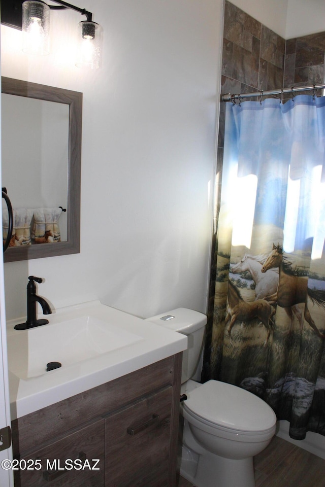 full bathroom featuring toilet, wood finished floors, vanity, and a shower with curtain