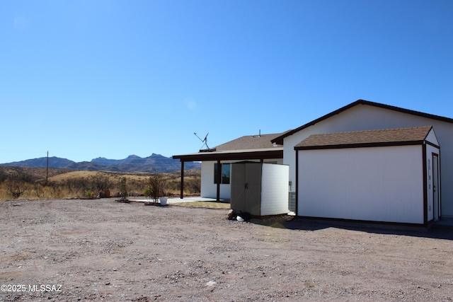 view of side of home with a mountain view