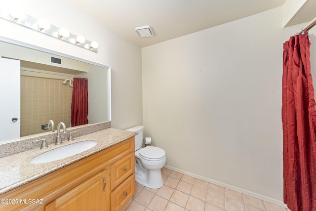 bathroom featuring visible vents, toilet, vanity, tile patterned flooring, and baseboards