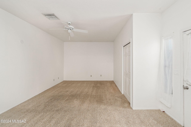 unfurnished bedroom with light colored carpet, visible vents, and ceiling fan