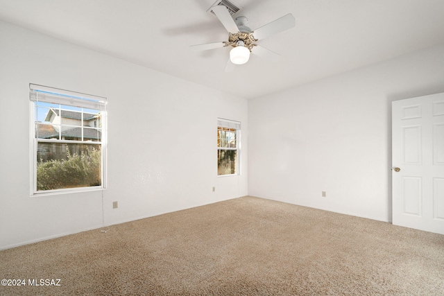 carpeted spare room with ceiling fan