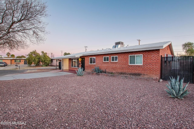 single story home featuring fence and brick siding