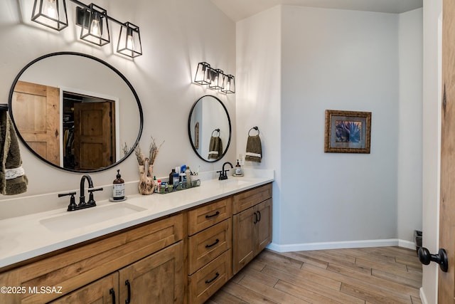 16 Star View Dr, Sonoita, AZ 85637 - bathroom with wood finished floors, baseboards, and double vanity