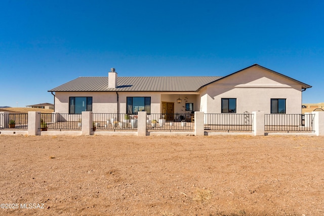 16 Star View Dr, Sonoita, AZ 85637 - back of property with stucco siding, a chimney, fence, metal roof, and a patio