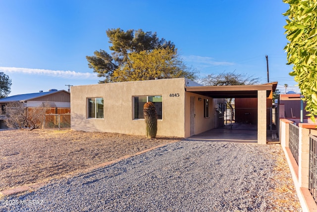 exterior space featuring fence and stucco siding