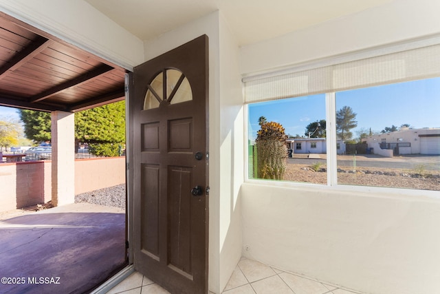 doorway to outside featuring tile patterned flooring and a healthy amount of sunlight