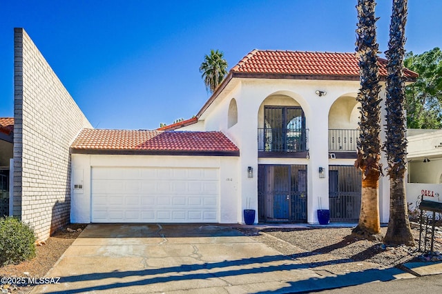 view of front of home with a garage, a balcony, a tile roof, and stucco siding