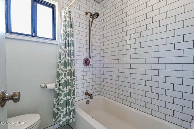 bathroom featuring shower / bath combo with shower curtain and toilet