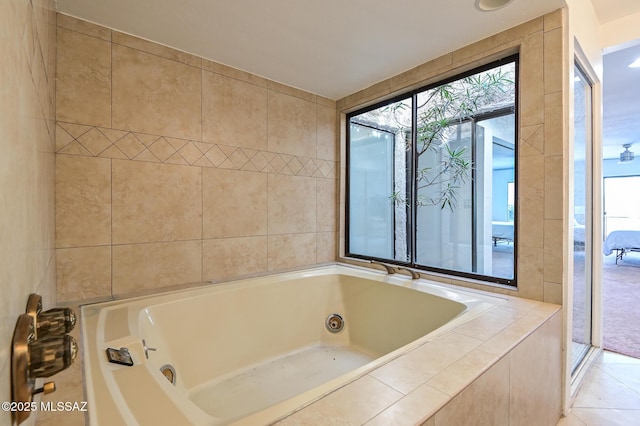 full bath with tile patterned flooring, a jetted tub, and tile walls