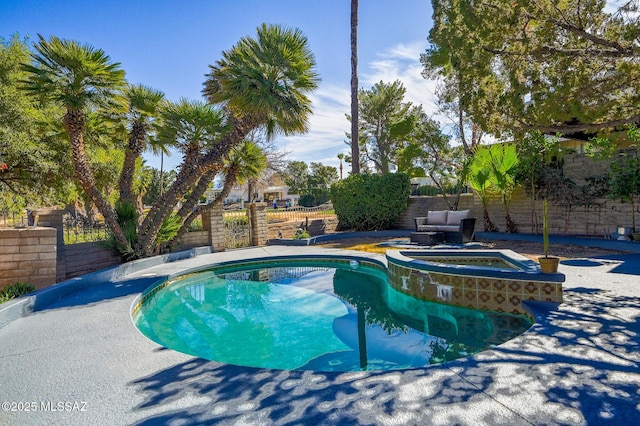 view of swimming pool featuring a fenced backyard and a pool with connected hot tub