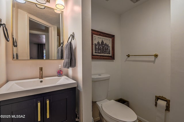 half bathroom featuring toilet and vanity