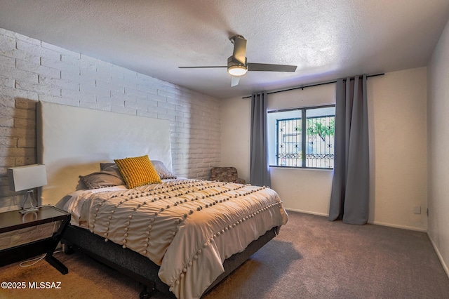 bedroom with a ceiling fan, baseboards, dark carpet, and a textured ceiling