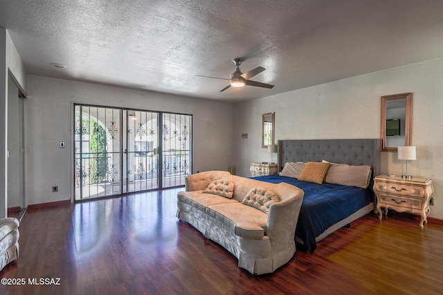 bedroom with baseboards, a ceiling fan, dark wood-type flooring, access to outside, and a textured ceiling