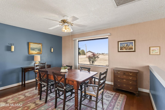 dining area with ceiling fan, wood finished floors, visible vents, and baseboards