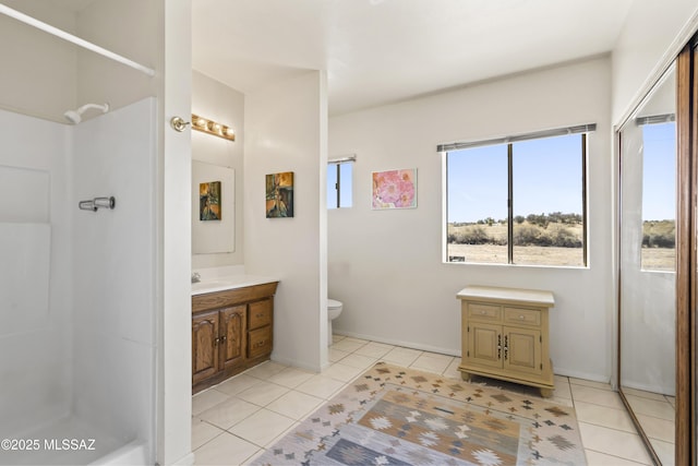 full bathroom with toilet, a shower, vanity, and tile patterned floors