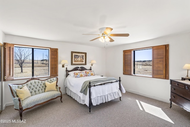 carpeted bedroom featuring baseboards and a ceiling fan