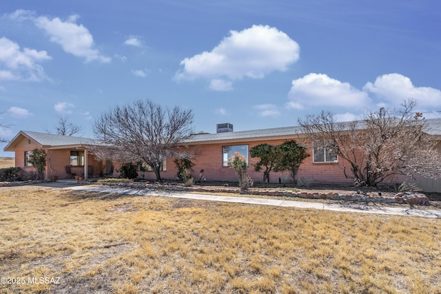 ranch-style house with brick siding and a front yard