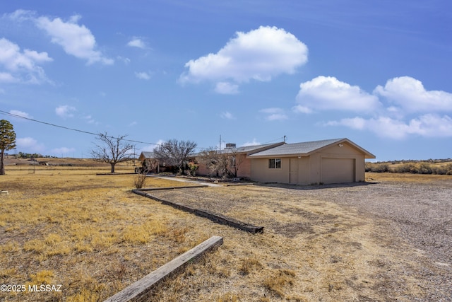 view of side of property with an attached garage and driveway