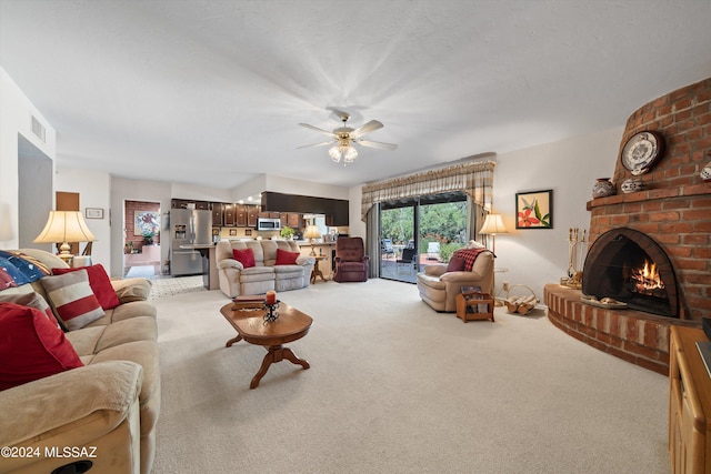 living room with visible vents, a fireplace, a ceiling fan, and light colored carpet