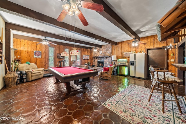 game room featuring billiards, wooden walls, a ceiling fan, beamed ceiling, and a fireplace