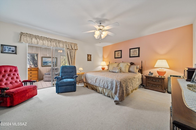 bedroom featuring light carpet and a ceiling fan