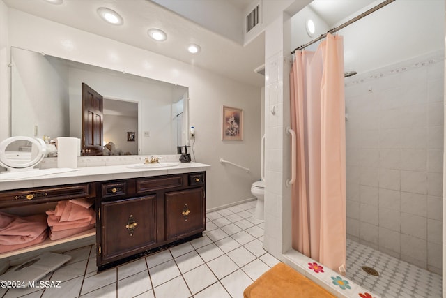 bathroom featuring toilet, vanity, visible vents, tile patterned floors, and a stall shower