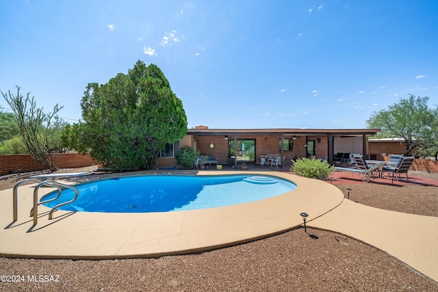 pool featuring a patio and fence