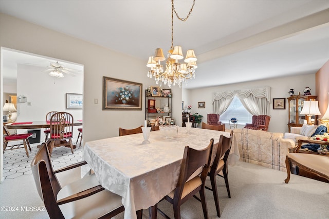 dining area featuring light carpet and ceiling fan with notable chandelier