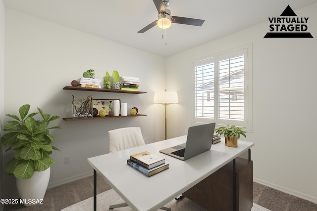 carpeted home office featuring baseboards and a ceiling fan