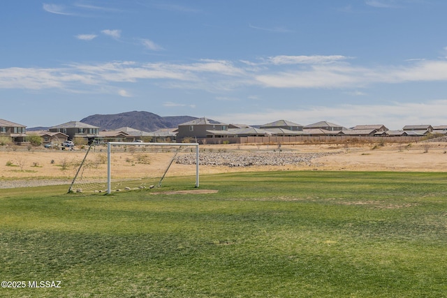 view of yard featuring a residential view and a mountain view