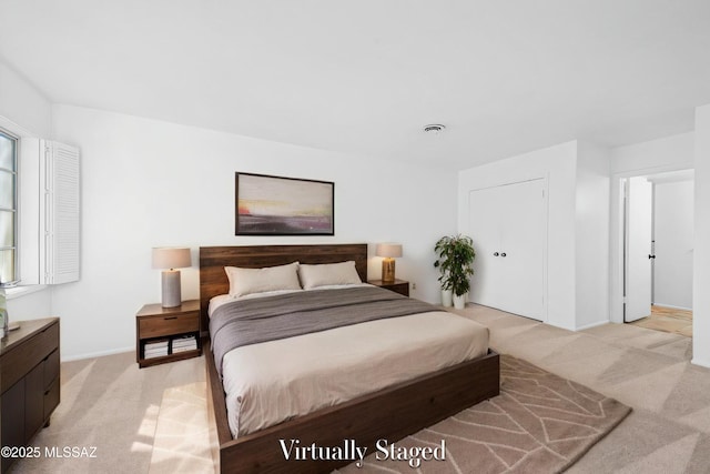 bedroom with light carpet and baseboards