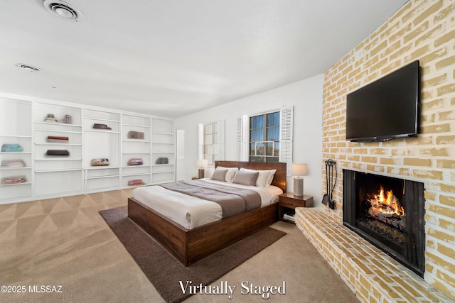 bedroom featuring a brick fireplace, visible vents, and light colored carpet