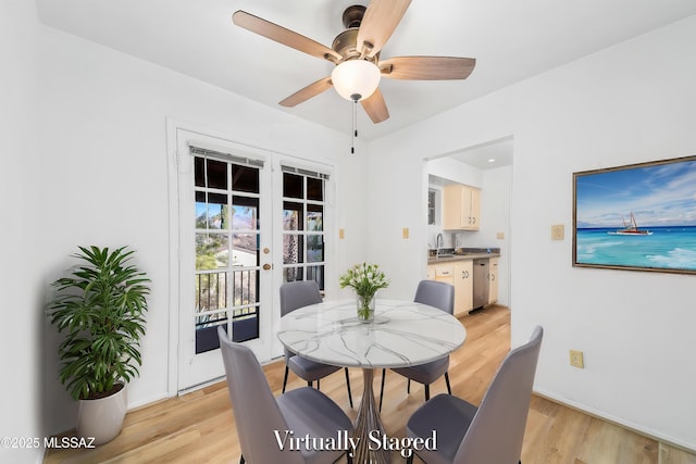 dining room with light wood-style flooring, a ceiling fan, and french doors