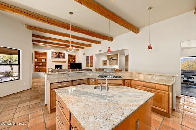 kitchen featuring a spacious island and light stone counters