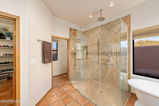 full bathroom featuring a closet, a soaking tub, a shower stall, and tile patterned floors