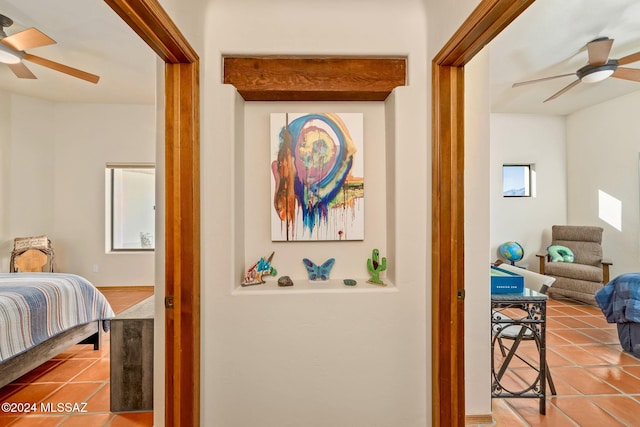 interior space with tile patterned flooring and a ceiling fan