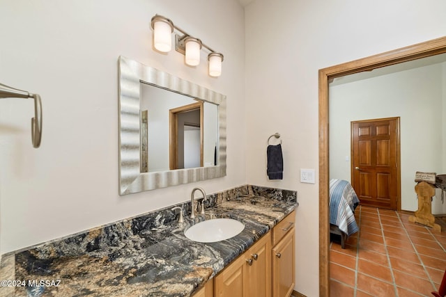 bathroom with tile patterned floors, vanity, and ensuite bathroom