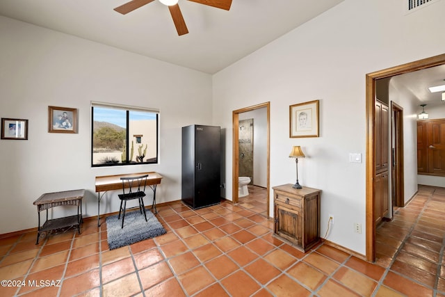 office with tile patterned flooring, ceiling fan, and baseboards