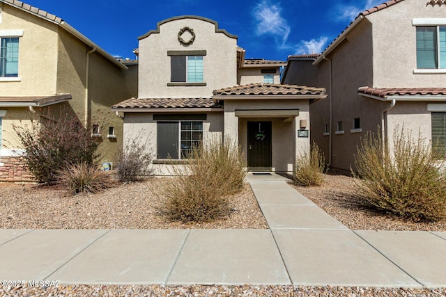 view of front of property featuring a tile roof and stucco siding