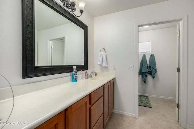 bathroom with tile patterned flooring, vanity, and baseboards