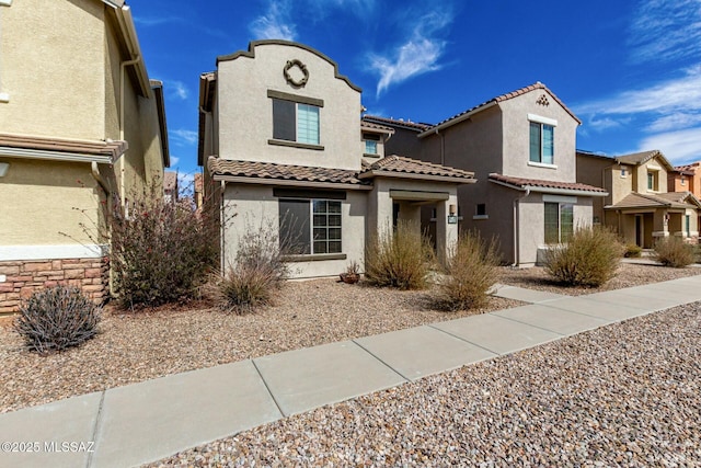 view of front of home with a tiled roof and stucco siding